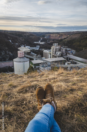 A person sitting on the lookout at Radotin cement plant, Prague photo