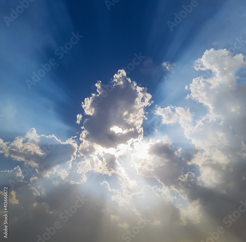 Blue sky with sun and clouds