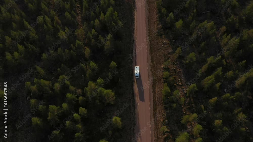 Aerial view away from a camper parked on the side of a road, in arctic tundra, sunny, summer day, in Lappland, Sweden - tilt up, drone shot Aerial view away from a camper parked on the side of a road, in arctic tundra, sunny, summer day, in Lappland, Sweden - tilt up, drone shot