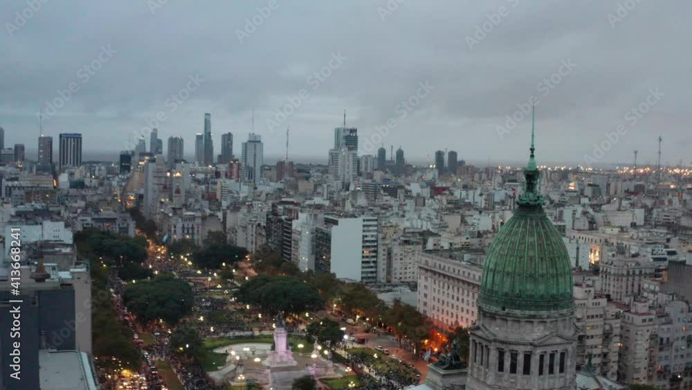 Aerial at dusk around the dome of the Palace of the Argentine National Congress at Plaza Congreso, Buenos Aires, Argentina. Slow drone rotating right to left pa Aerial at dusk around the dome of the Palace of the Argentine National Congress at Plaza Congreso, Buenos Aires, Argentina. Slow drone rotating right to left pa