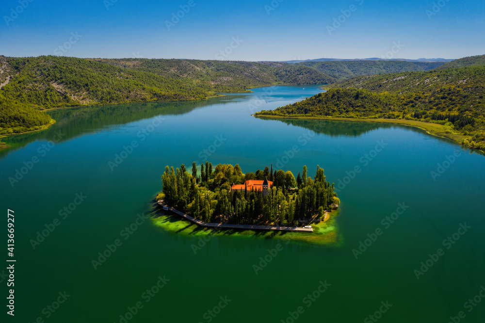 Visovac, Christian monastery, Croatia. Little island on river Krk in National Park Krk. Aerial drone shot in september 2020