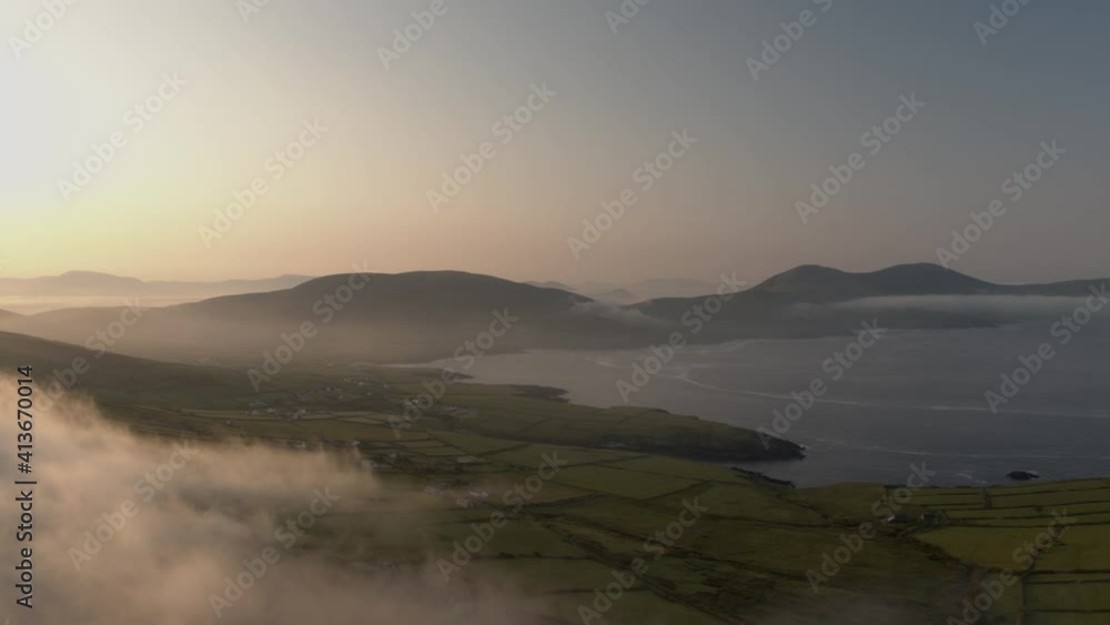 Early morning clouds drift over the mountains in Co Kerry Ireland as the sun shines during the summer. Early morning clouds drift over the mountains in Co Kerry Ireland as the sun shines during the summer.
