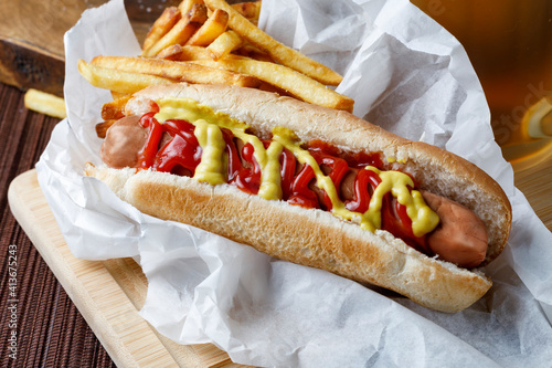 Hot dog with fries and beer photo