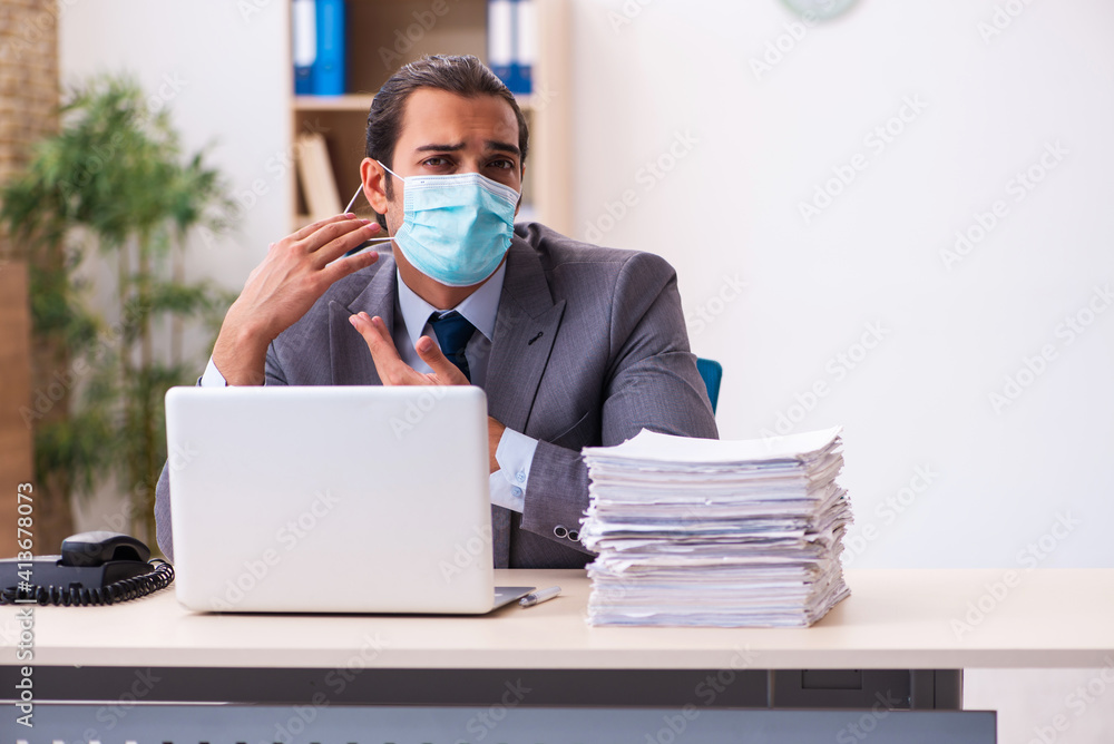 Young male employee wearing mask during pandemic Young male employee wearing mask during pandemic