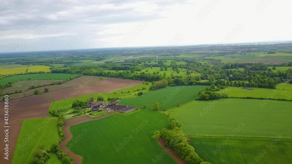 Flight over British countryside with green and yellow fields Flight over British countryside with green and yellow fields