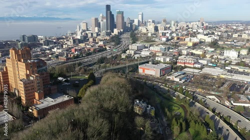 Cinematic aerial drone pan shot of Pacific Tower, First Hill, Yesler Terrace, Atlantic, Cherry Hill, Squire Park, skyscrapers and high-rise commercial and residential buildings downtown Seattle photo