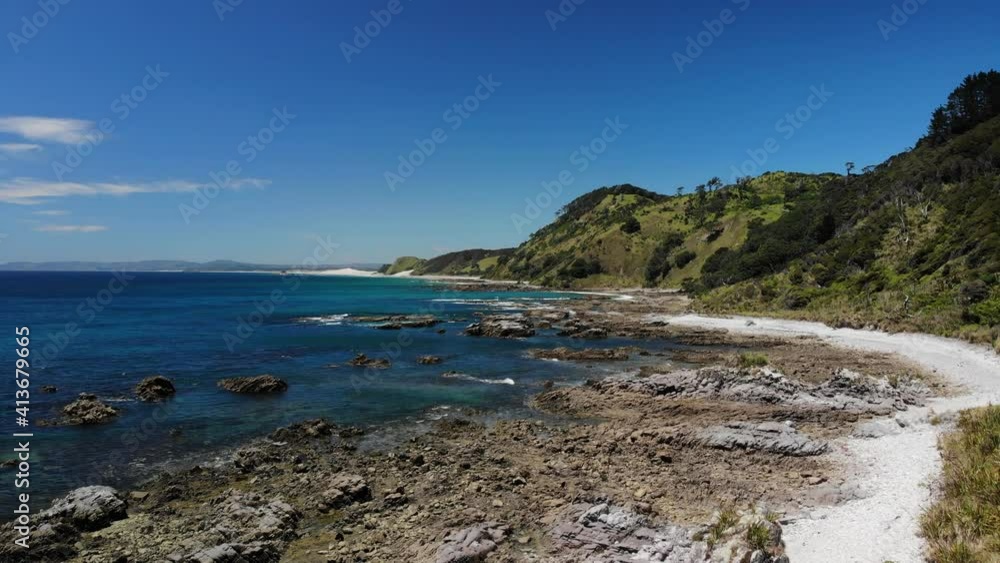 Scenic coastline at Mangawhai, popular tourist spot in New Zealand. Drone rising shot, sand dune in a distance Scenic coastline at Mangawhai, popular tourist spot in New Zealand. Drone rising shot, sand dune in a distance