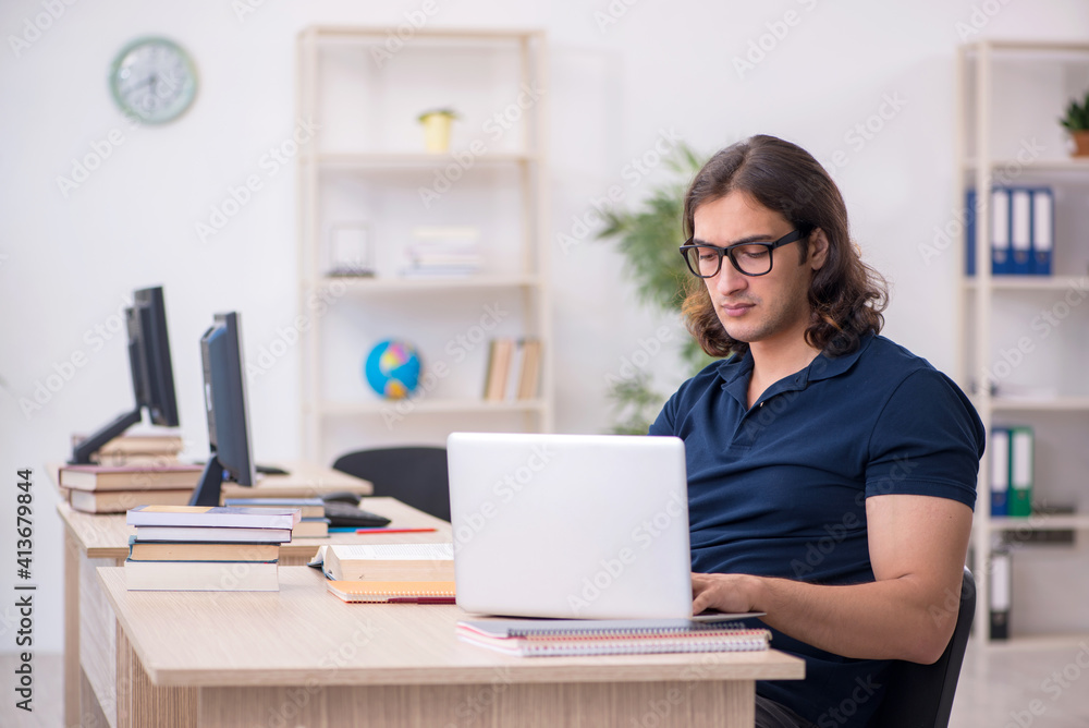 Young male student in tele-education concept Young male student in tele-education concept