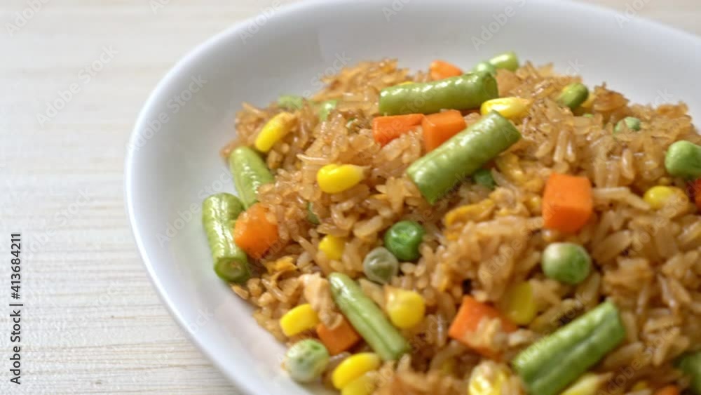 fried rice with green peas, carrot and corn - vegetarian and healthy food style fried rice with green peas, carrot and corn - vegetarian and healthy food style