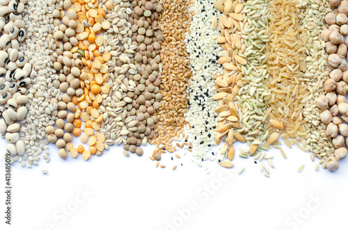 Collection of dry organic cereal and grain seed stripe consisted of black eye pea, pearl barley, soybeean, lentil, flax seed, sesame, melon and rice seeds on white background