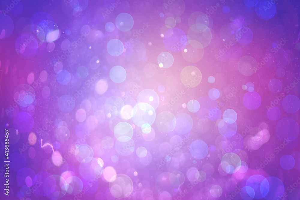 Abstract illustration of bokeh spots of light against blue and purple gradient background