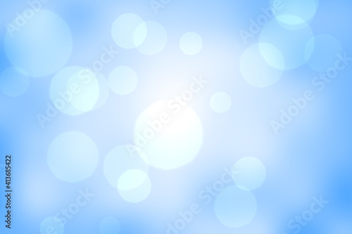 Abstract illustration of bokeh spots of light against blue background