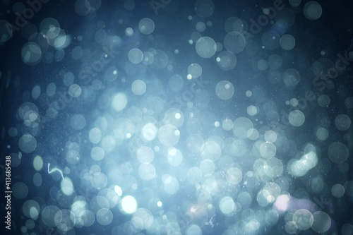 Abstract illustration of bokeh spots of light against blue background