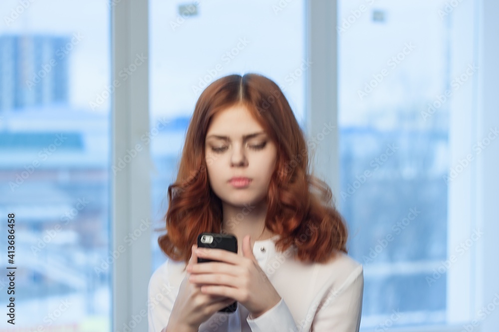Business woman in white shirt with phone in hands communication technology office