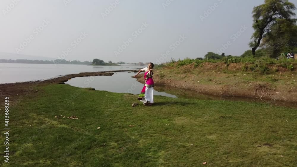 A bharatnatyam dancer displaying a classical bharatnatyam pose in the nature of Vadatalav lake, Pavagadh. Beautiful indian girl dancer in the posture of Indian classical dance bharatanatyam . A bharatnatyam dancer displaying a classical bharatnatyam pose in the nature of Vadatalav lake, Pavagadh. Beautiful indian girl dancer in the posture of Indian classical dance bharatanatyam .