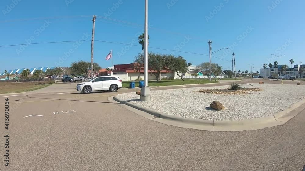 POV, drivers window point of view while driving a residential road on North Padre Island, Texas; visible are condominiums, houses, canals, and boat docks - Whitecap Boulevard POV, drivers window point of view while driving a residential road on North Padre Island, Texas; visible are condominiums, houses, canals, and boat docks - Whitecap Boulevard
