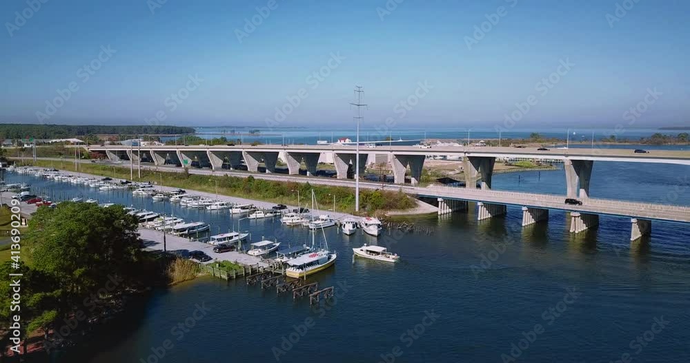 Kent Narrows, MD waterway shot overhead with DJI Mavic Pro drone with low speed movement in 4K 24fps. Flying towards bridge, with left turn following a boat into the marina, passing anchored boats Kent Narrows, MD waterway shot overhead with DJI Mavic Pro drone with low speed movement in 4K 24fps. Flying towards bridge, with left turn following a boat into the marina, passing anchored boats