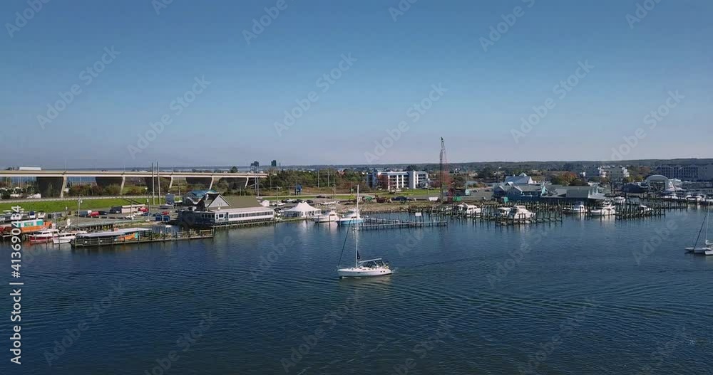Kent Narrows, MD waterway shot overhead with DJI Mavic Pro drone with low speed movement in 4K 24fps. Slight left pan following sailboat passing by Kent Narrows, MD waterway shot overhead with DJI Mavic Pro drone with low speed movement in 4K 24fps. Slight left pan following sailboat passing by