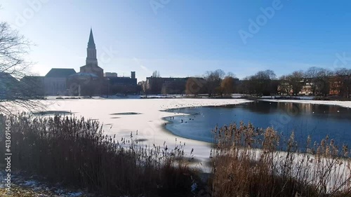 Winter in Kiel. Wide Angle shot of the lake kleiner Kiel in front of the Town Hall. Half frozen lake and blue sky photo