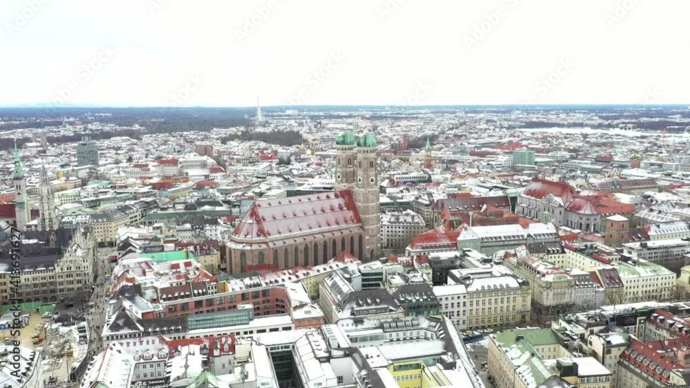 AERIAL: Gothic Church with iconic domed towers covered in snow in Munich, Germany AERIAL: Gothic Church with iconic domed towers covered in snow in Munich, Germany