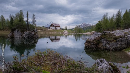 Motion-lapse of clouds reflecting on Federa lake and Palmieri refuge. Italy photo