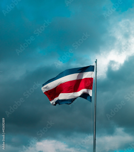 Costa Rica flag with dark clouds in background
