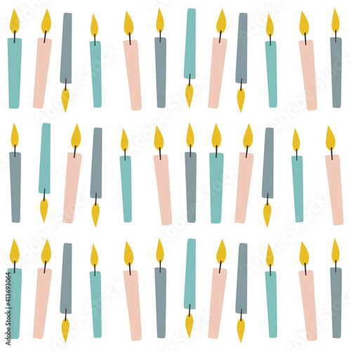 Multiple colourful lit candles in rows over white background
