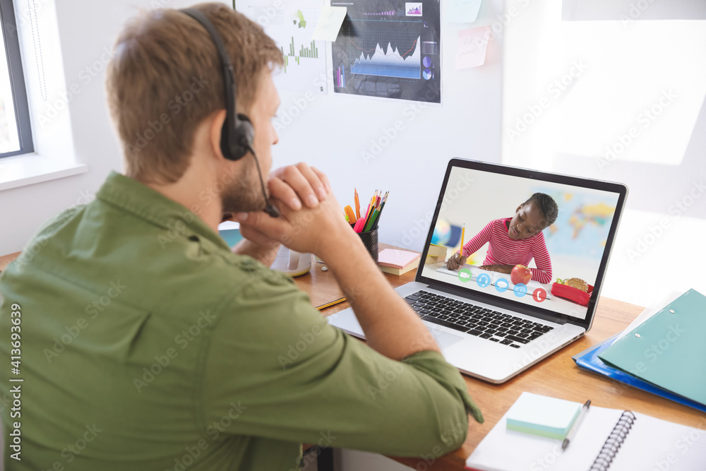 Caucasian male teacher using laptop and phone headset on video call with schoolboy learning from hom Caucasian male teacher using laptop and phone headset on video call with schoolboy learning from hom