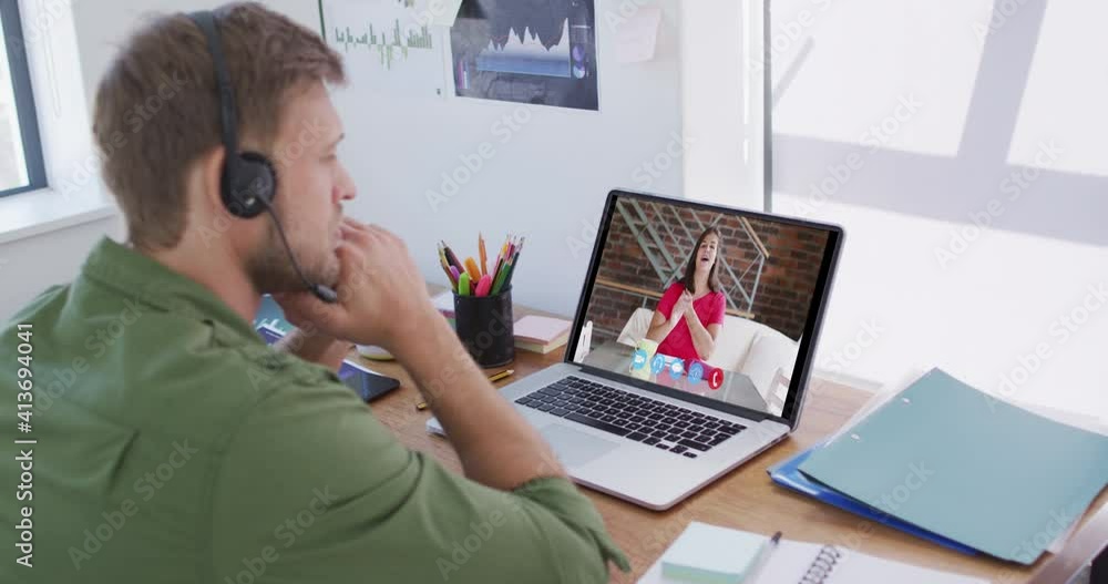 Caucasian man using laptop and phone headset on video call with female colleague Caucasian man using laptop and phone headset on video call with female colleague