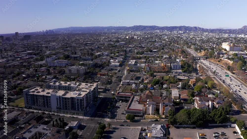 Panning aerial shot above Echo Park towards Mid-Wilshire city center district. HD at 60 FPS. Panning aerial shot above Echo Park towards Mid-Wilshire city center district. HD at 60 FPS.