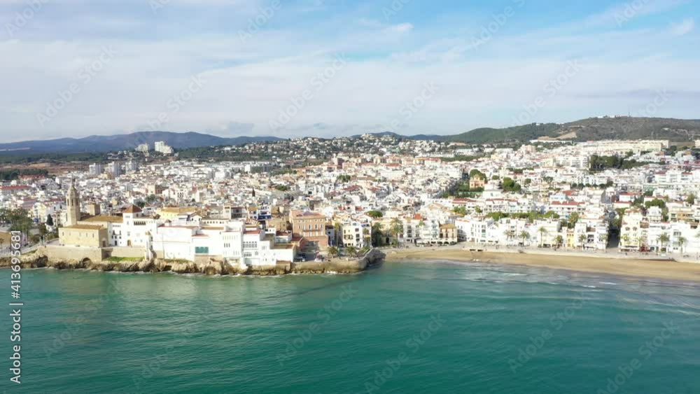 AERIAL: Wide shot of ocean and city in Sitges, Spain AERIAL: Wide shot of ocean and city in Sitges, Spain
