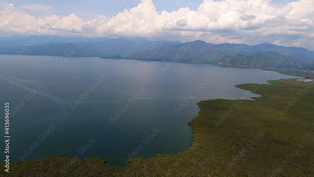 Wide angle aerial ocean view and green mountain background at day Wide angle aerial ocean view and green mountain background at day