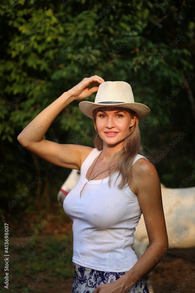 Girl in a cowboy hat at sunset