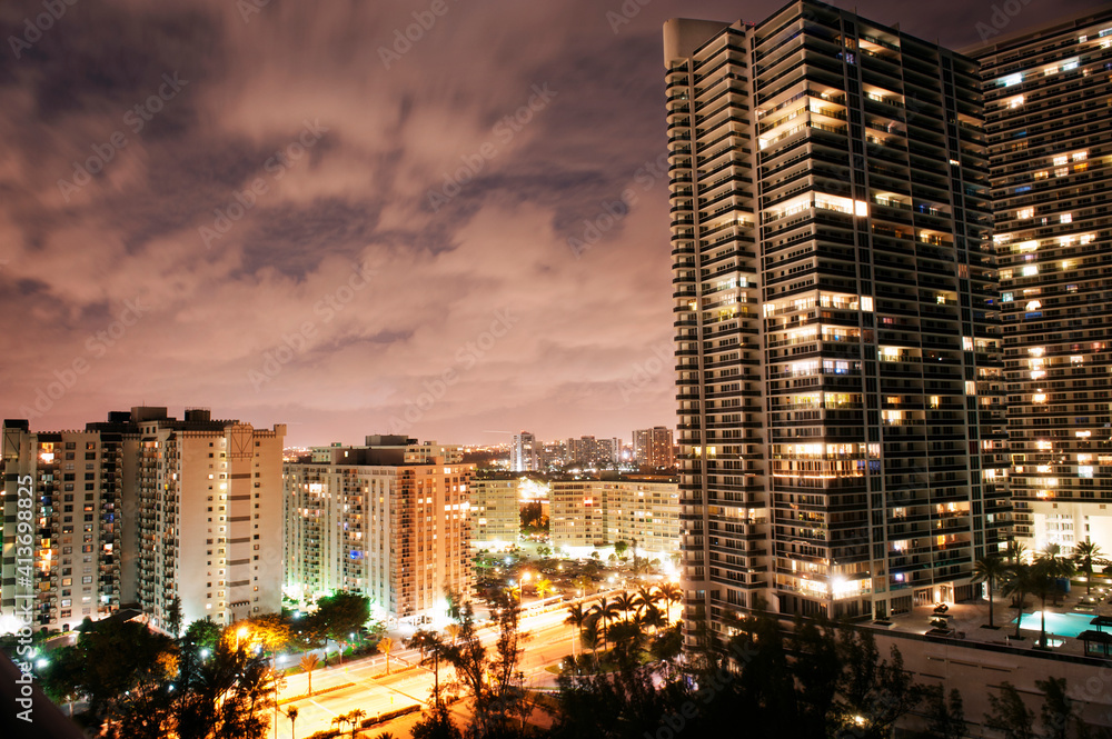Illuminated cityscape against cloudy sky at dusk Illuminated cityscape against cloudy sky at dusk