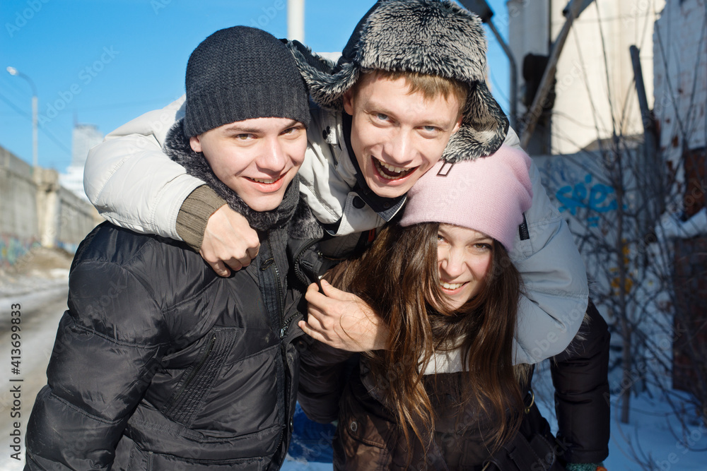 Portrait of cheerful man embracing friends on sunny day Portrait of cheerful man embracing friends on sunny day