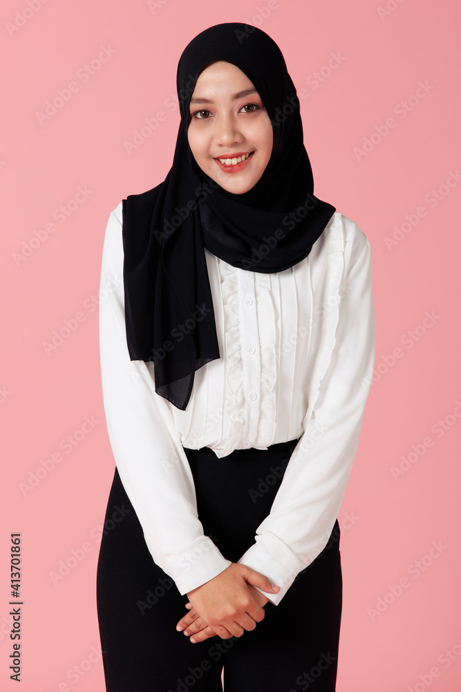 Portrait of young and cute Asian Islamic woman pose to camera with smile and happy face Portrait of young and cute Asian Islamic woman pose to camera with smile and happy face