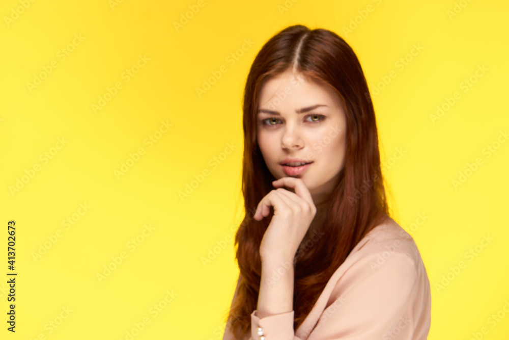 pretty woman holding hand near face charm luxury yellow background pretty woman holding hand near face charm luxury yellow background