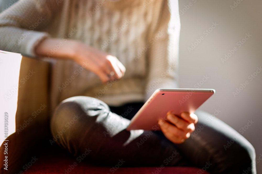 Mid section of woman holding tablet computer at home Mid section of woman holding tablet computer at home