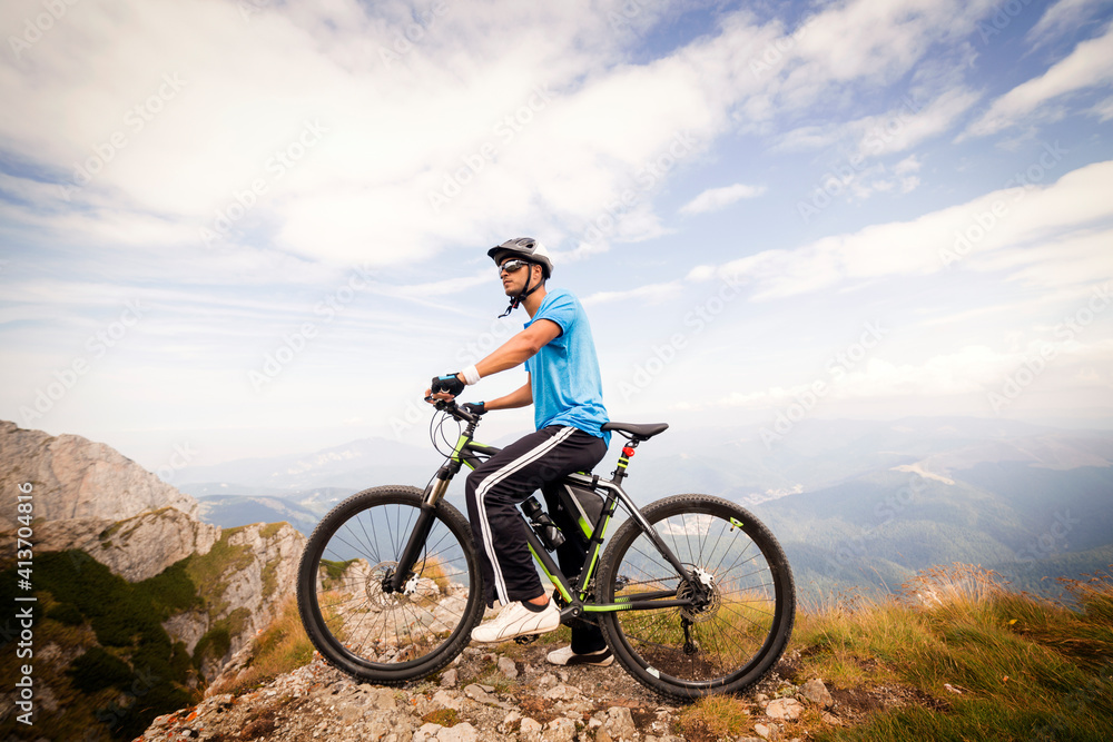 Side view of cyclist with bicycle against cloudy sky Side view of cyclist with bicycle against cloudy sky