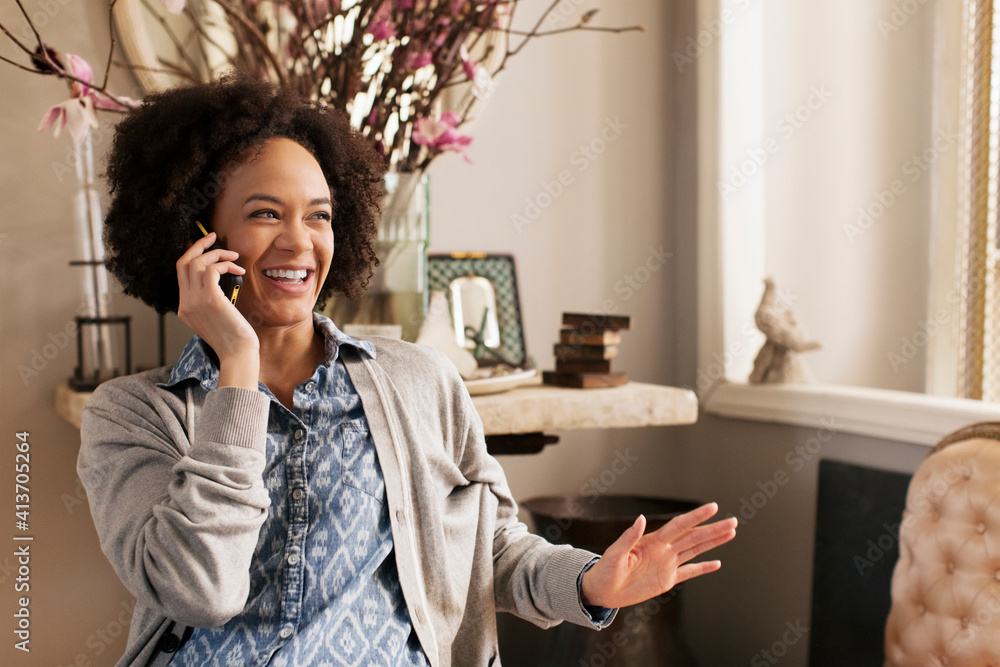 Happy woman talking on smart phone at home Happy woman talking on smart phone at home