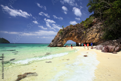 Tourist visit Koh Khai, rock arch landmark, Satun