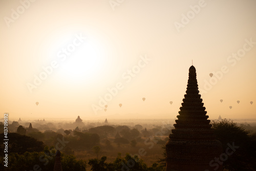 a sunrising with pagodas and balloon 