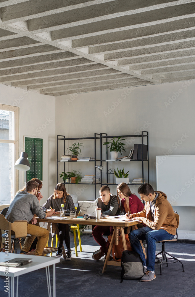 Students studying at table by window in classroom Students studying at table by window in classroom