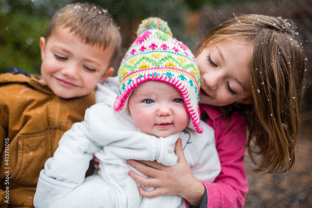 Portrait of cute baby girl with siblings at backyard Portrait of cute baby girl with siblings at backyard