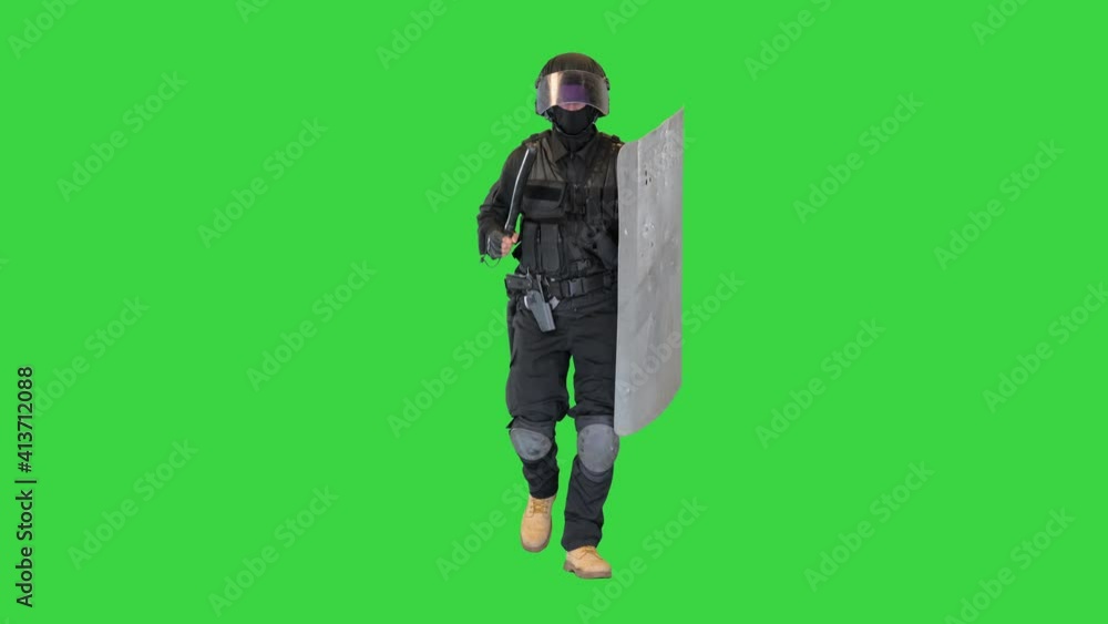 Soldier in full uniform with armor, baton, protective shield running on a Green Screen, Chroma Key. Soldier in full uniform with armor, baton, protective shield running on a Green Screen, Chroma Key.