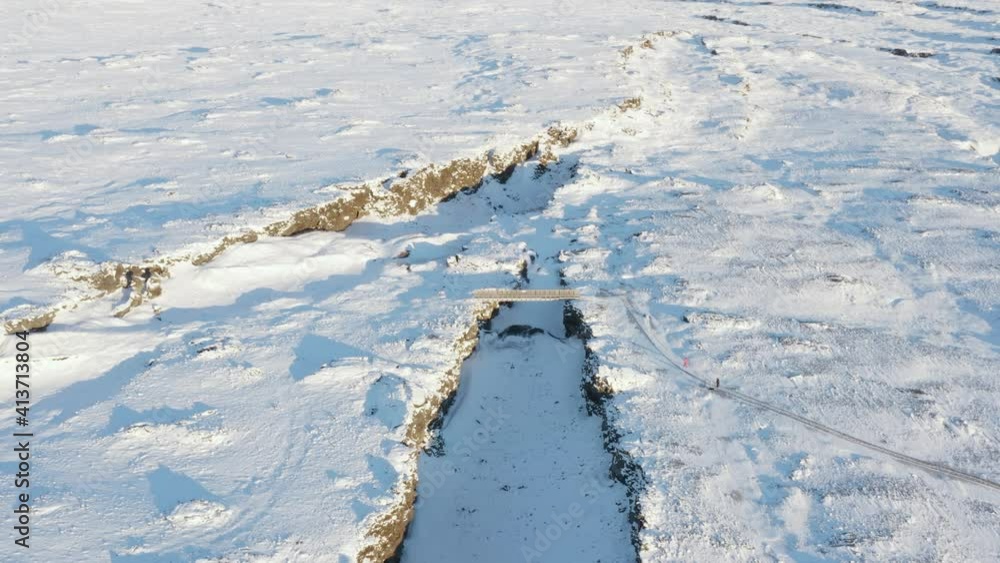 Stunning winter landscape at bridge crossing tectonic plates in Iceland