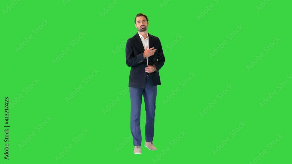 Young businessman in suit talking to camera on a Green Screen, Chroma Key. Young businessman in suit talking to camera on a Green Screen, Chroma Key.