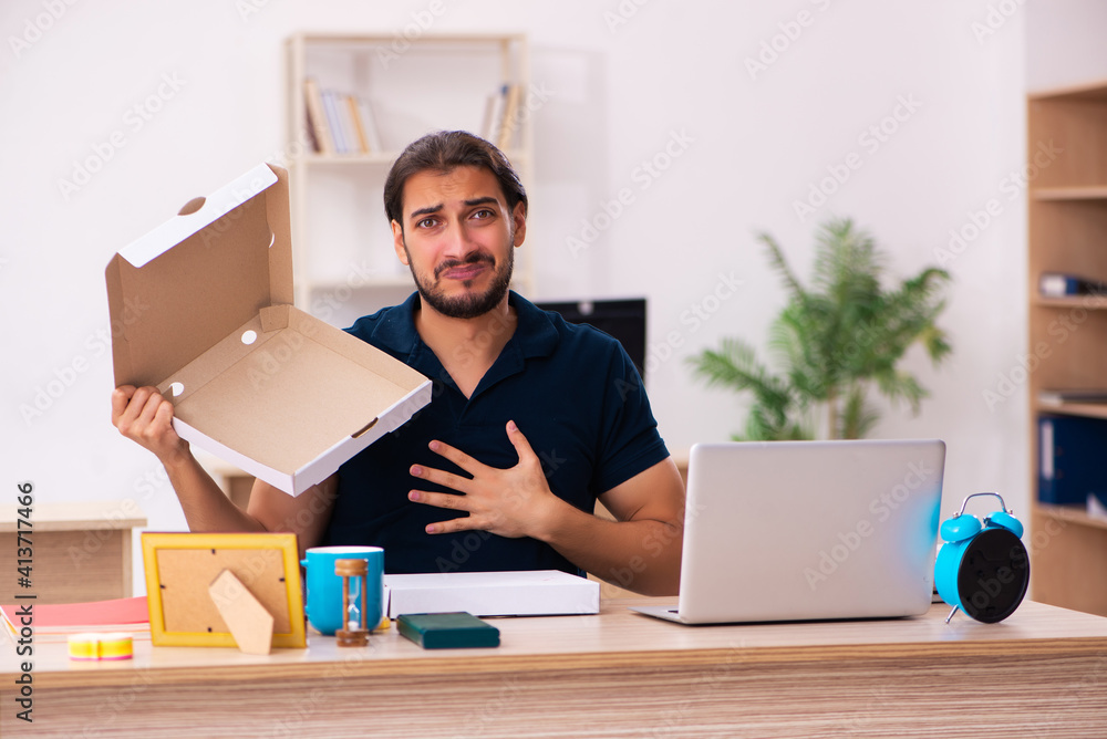 Young male employee ordering pizza at workplace Young male employee ordering pizza at workplace