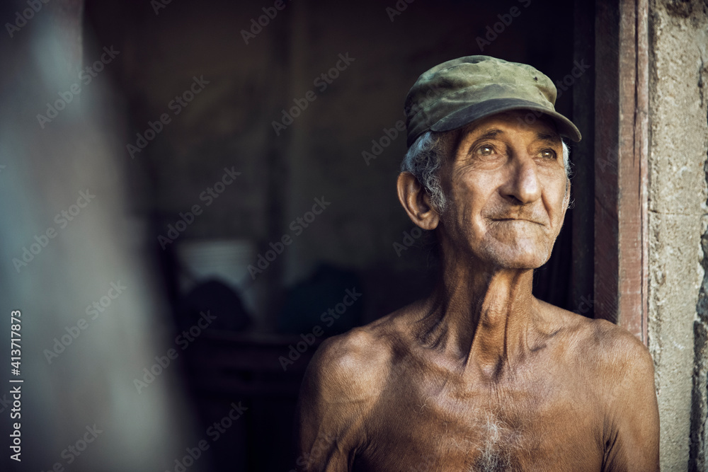 Thoughtful man looking away while standing at doorway Thoughtful man looking away while standing at doorway