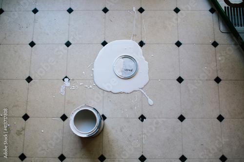 Overhead view of spilled paint on floor at home